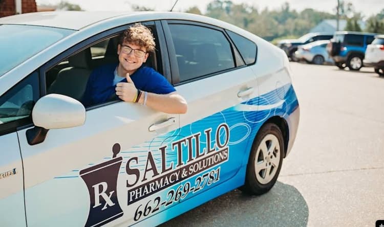 Pharmacist helping a patient at the counter.